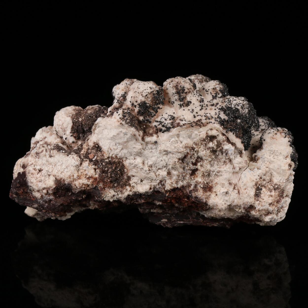 Groutite On Manganoan Calcite