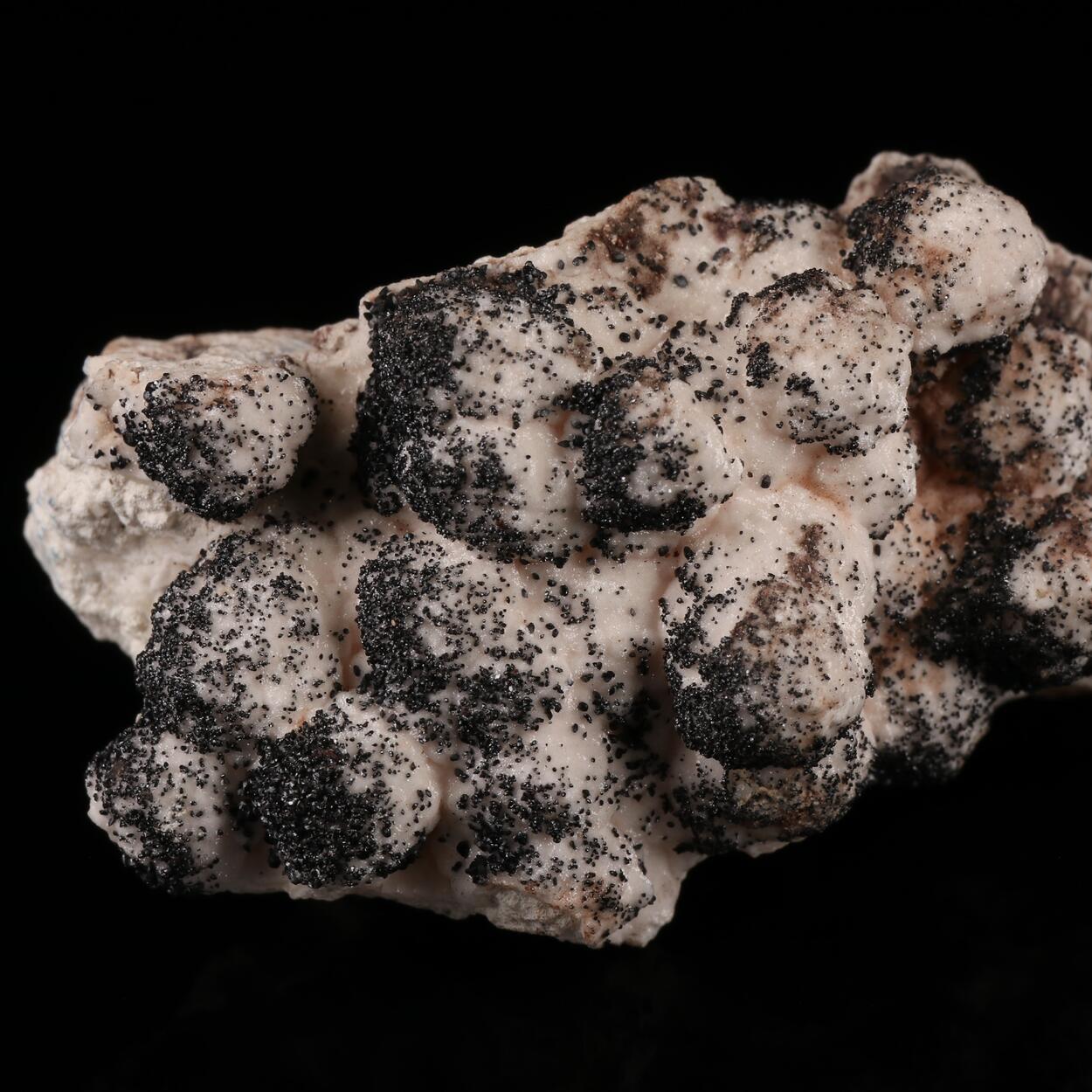 Groutite On Manganoan Calcite