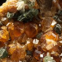 Grossular Var Hessonite On Clinochlore